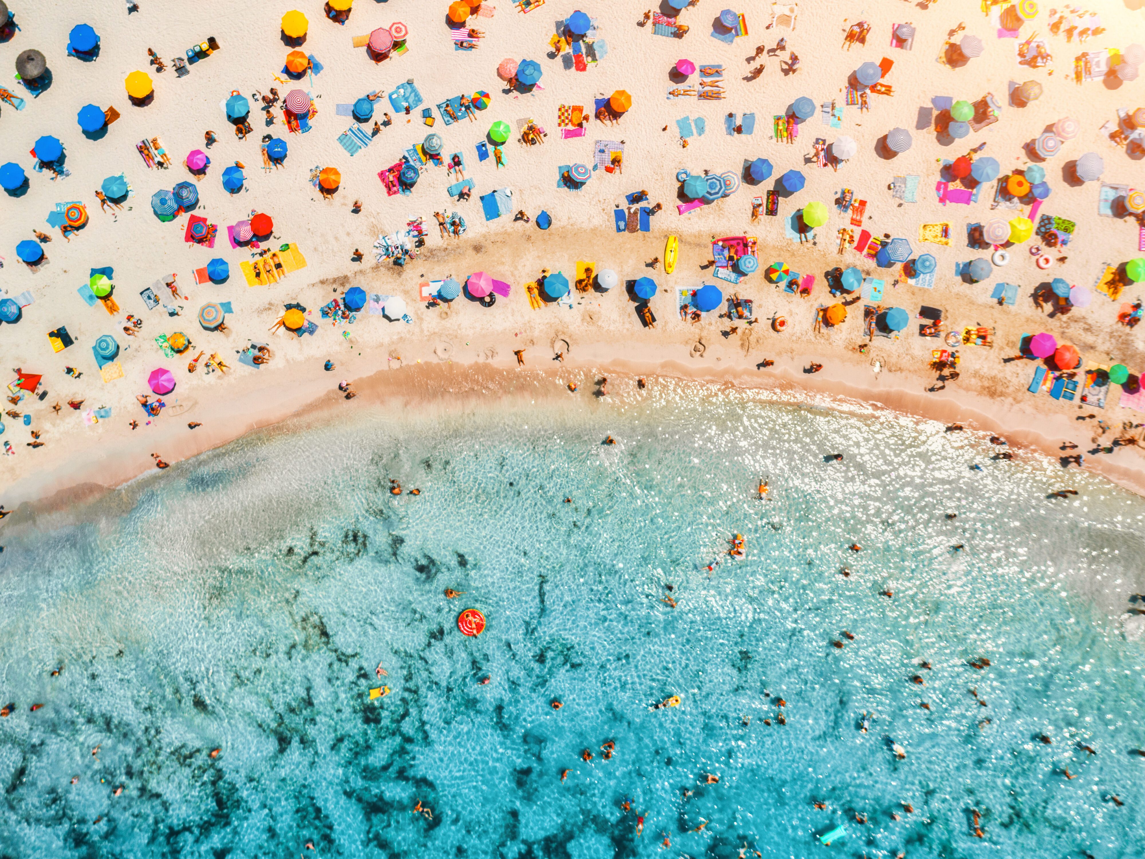 Aerial,View,Of,Sandy,Beach,With,Colorful,Umbrellas,,Swimming,People Mallorca Urlaub