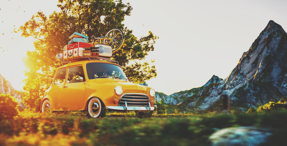 Cute,Little,Retro,Car,With,Suitcases,And,Bicycle,On,Top
